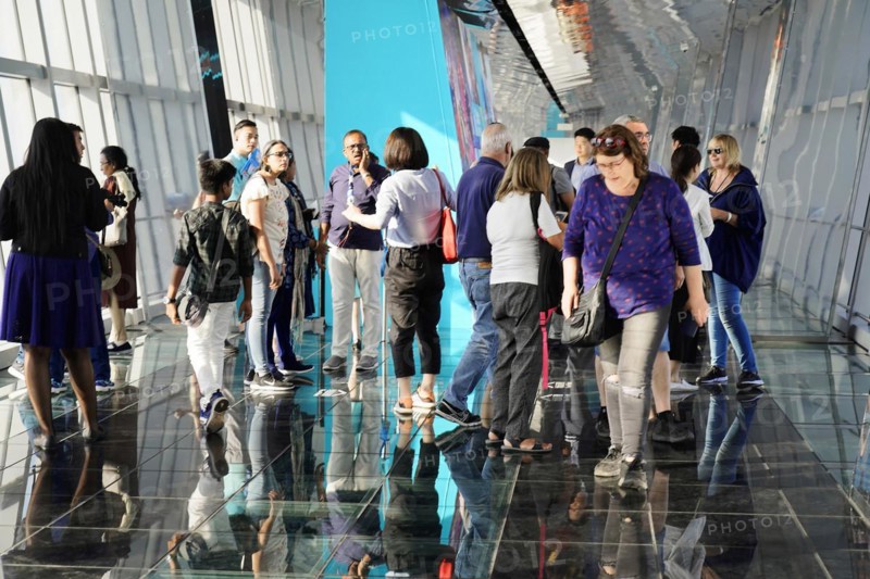 Viewing terrace, The Bottle Opener at 492 metres, A group of people stand in a modern glass building with many reflections, Shanghai, China, Asia