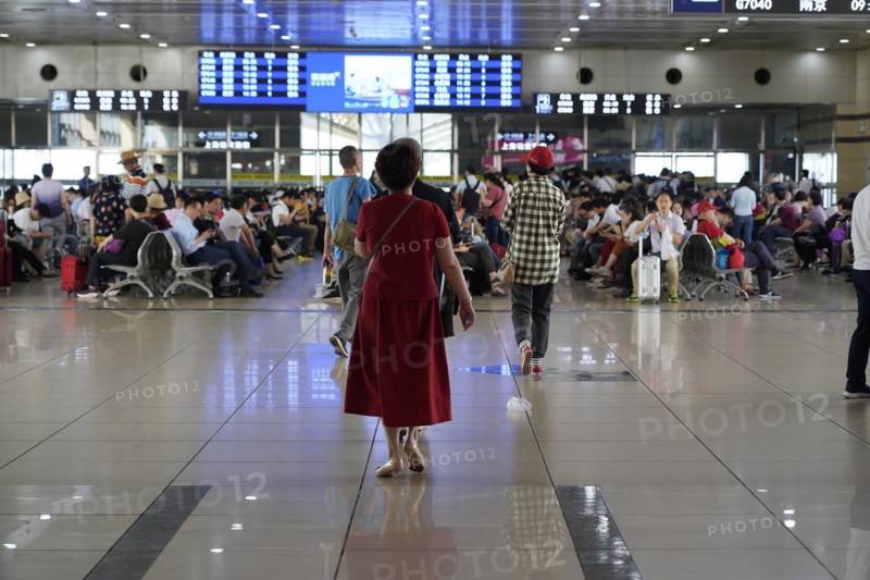 Hongqiao Railway Station, Shanghai, China, Asia, A person in red clothing walks through an airport waiting area, Yichang, Hubei Province, Asia