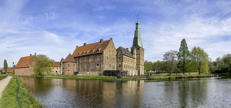 Panoramic photo View over moat to historic moated castle from Renaissance Raesfeld Castle reflected in moat in spring, Freiheit Raesfeld, Muensterland, North Rhine-Westphalia, Germany, Europe
