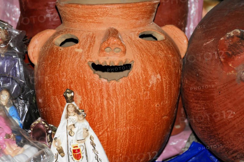 AUGUSTO C. SANDINO Airport, Managua, A red clay vessel with a carved face surrounded by other handicraft items, Nicaragua, Central America, Central America