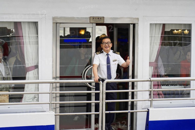 Chongqing, Chongqing Province, China, A ship officer in uniform smiles and greets friendly from a ship's door, Chongqing, Chongqing, Chongqing Province, China, Asia