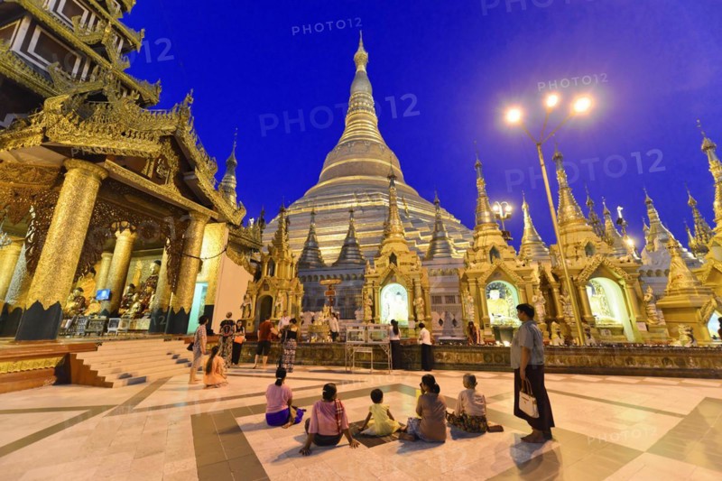 Shwedagon Pagoda, Yangon, Myanmar, Asia, visitors surrounded by golden structures of the pagoda at dusk, filled with tranquillity, Asia