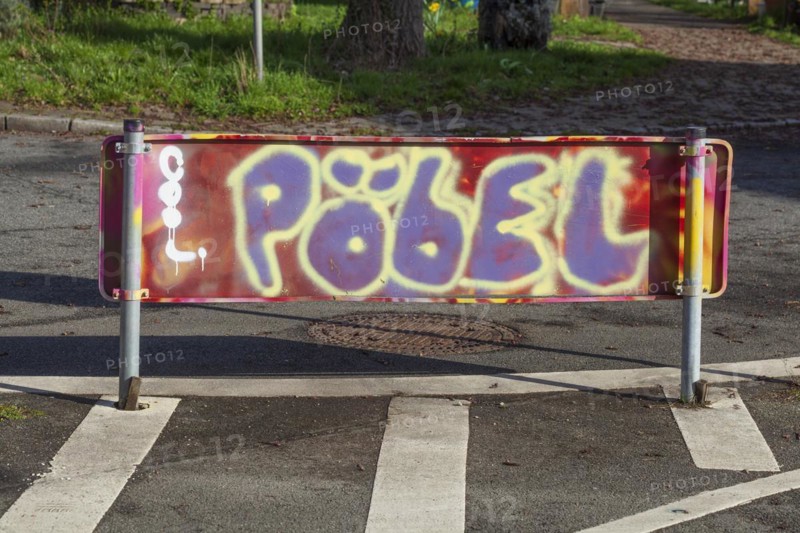 Colourfully smeared traffic sign with the inscription Poebel, Germany, Europe