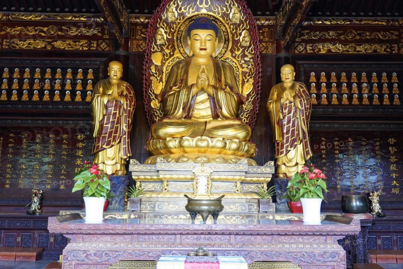 Chongqing, Chongqing Province, China, Asia, Symmetrical arrangement of golden Buddha statues inside a Chinese temple, Asia