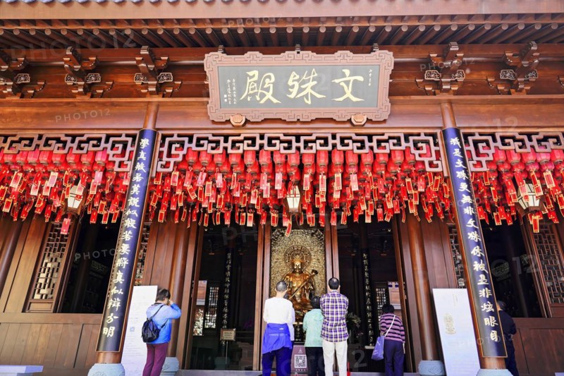 Jade Buddha Temple, Shanghai, Visitors pray in front of a traditional temple with red lanterns and a wooden structure, Shanghai, China, Asia