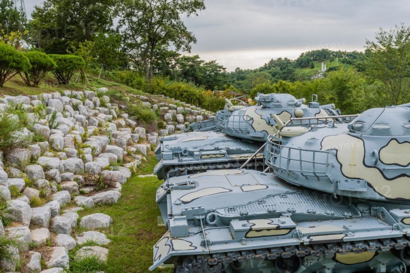 Closeup of gun turret on military tanks with camouflage paint on display in public park in Nonsan, South Korea, Asia