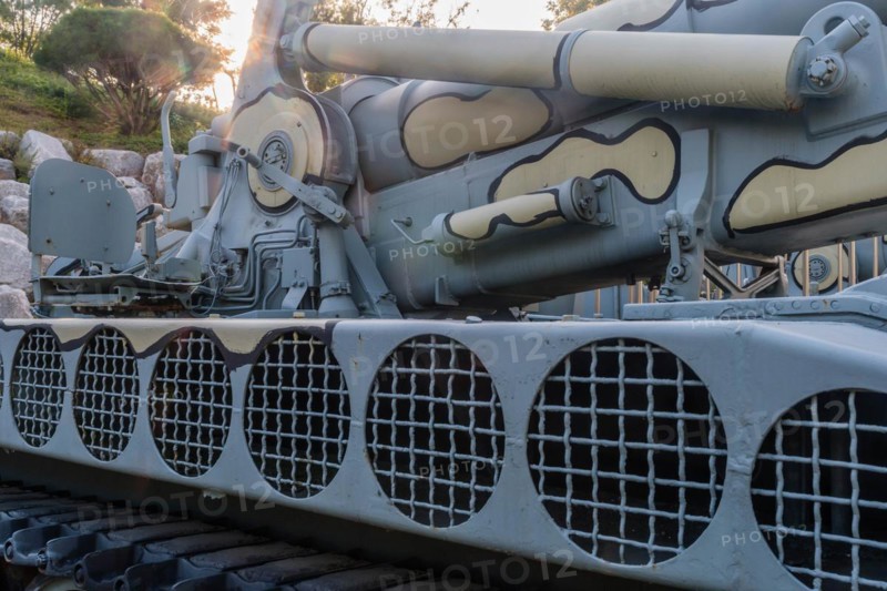 Closeup of camouflaged army tank with side view of vents above track and chair on rear portion of vehicle in Nonsan, South Korea, Asia