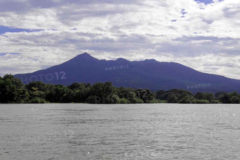 Granada, Nicaragua, Wide view of Lake Nicaragua in front of a mountain, spanned by a blue sky with clouds, Central America, Central America