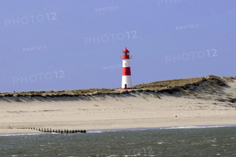 Lighthouse with blue sky at the elbow, North Sea, North Sea island, island, Sylt, red and white lighthouse on a sand dune under blue sky, Sylt, North Frisian island, Schleswig Holstein, Germany, Europe