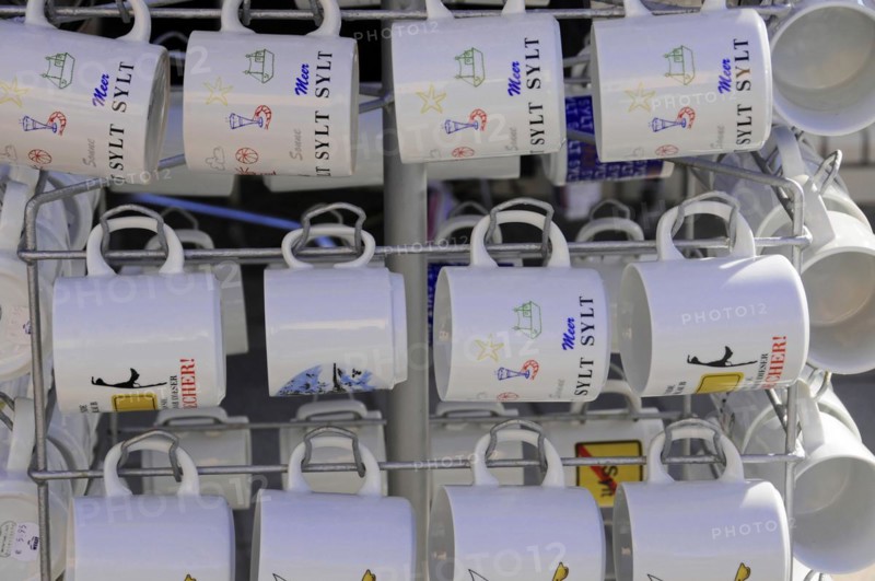 Sylt, North Frisian Island, Schleswig-Holstein, White cups hanging on a rack with various Sylt motifs, Sylt, North Frisian Island, Schleswig-Holstein, Germany, Europe