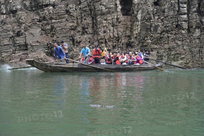 Special boats for the side arms of the Yangtze, for the tourists of the river cruise ships, Yichang, China, Asia, passengers in traditional clothes on a boat surrounded by rocks, Hubei province, Asia