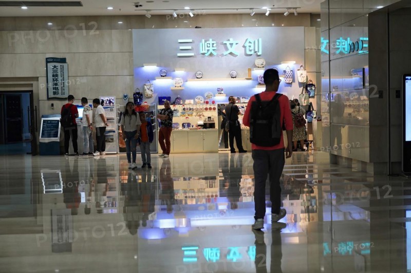 Chongqing, Chongqing Province, China, Asia, People in a shopping area with shiny floors and brightly lit advertising signs, Asia