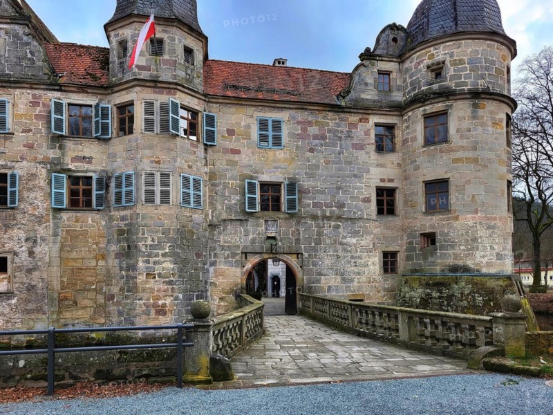Mitwitz moated castle under a cloudy sky. Mitwitz, Kronach, Upper Franconia, Bavaria, Germany, Europe