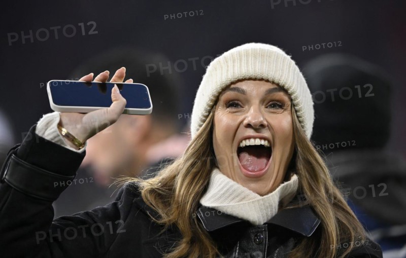 TV presenter Laura Wontorra DAZN, portrait, cap, laughs, waves to her fans, smartphone, mobile phone, Allianz Arena, Munich, Bavaria, Germany, Europe