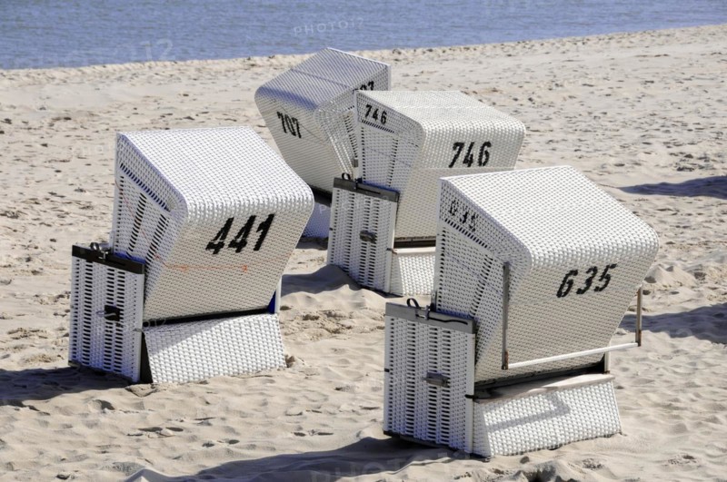 On the beach, Hoernum, Sylt, North Frisian Island, White beach chairs with numbers on a sandy beach in sunny weather, Sylt, North Frisian Island, Schleswig-Holstein, Germany, Europe
