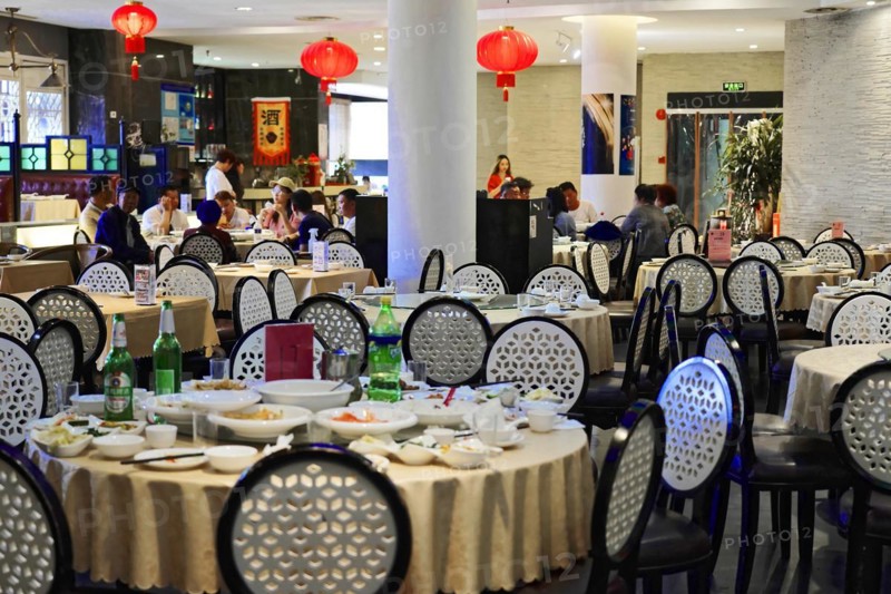 Dinner in a posh restaurant in Shanghai, China, Asia, Guests sitting at round tables in a Chinese restaurant with traditional decoration, Shanghai, Asia