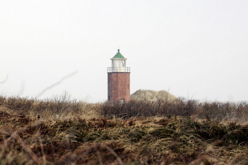 Lighthouse of Kampen, Small brick lighthouse stands between dunes under a cloudy sky, Sylt, North Frisian Island, Schleswig Holstein, Germany, Europe