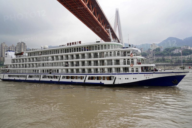 Chongqing, Chongqing Province, China, Side view of a large white cruise ship sailing on a river, Chongqing, Chongqing, Chongqing Province, China, Asia