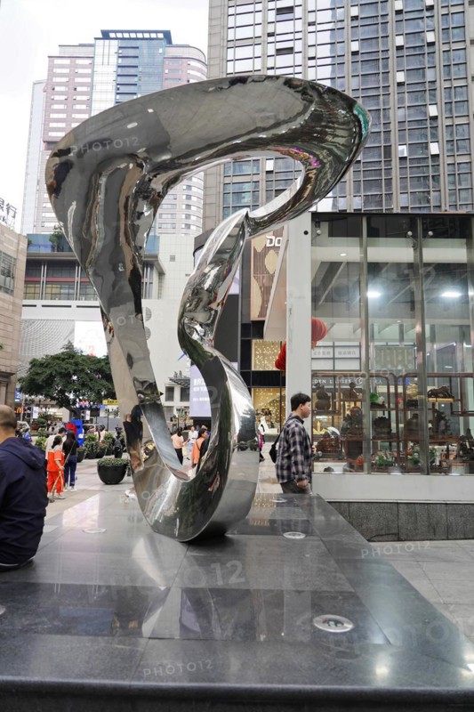 Stroll in Chongqing, Chongqing Province, China, Asia, A spiral-shaped reflective sculpture stands against an urban background, Chongqing, Asia