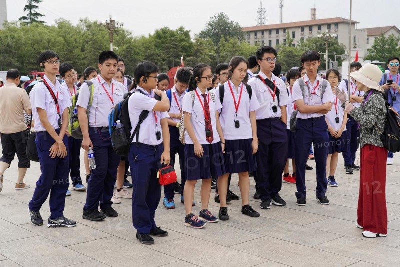 Beijing, China, Asia, school class in uniforms with medals listens to a guide during a city tour, Asia