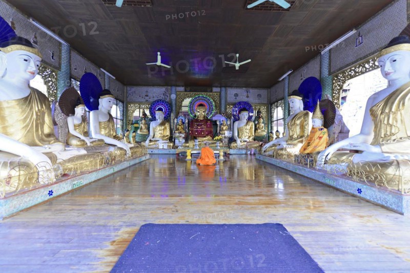 Shwedagon Pagoda, Yangon, Myanmar, Asia, A monk meditates between golden Buddha statues in a temple, Asia