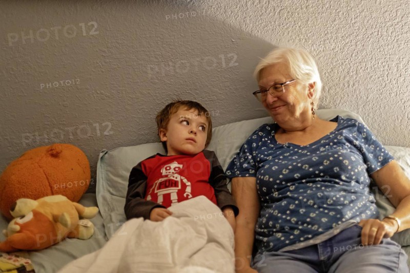 Denver, Colorado, Hendrix Hjermstad, 5, with his grandmother, Susan Newell, 75, at bedtime