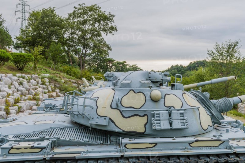 Closeup of gun turret on military tank with camouflage paint on display in public park in Nonsan, South Korea, Asia