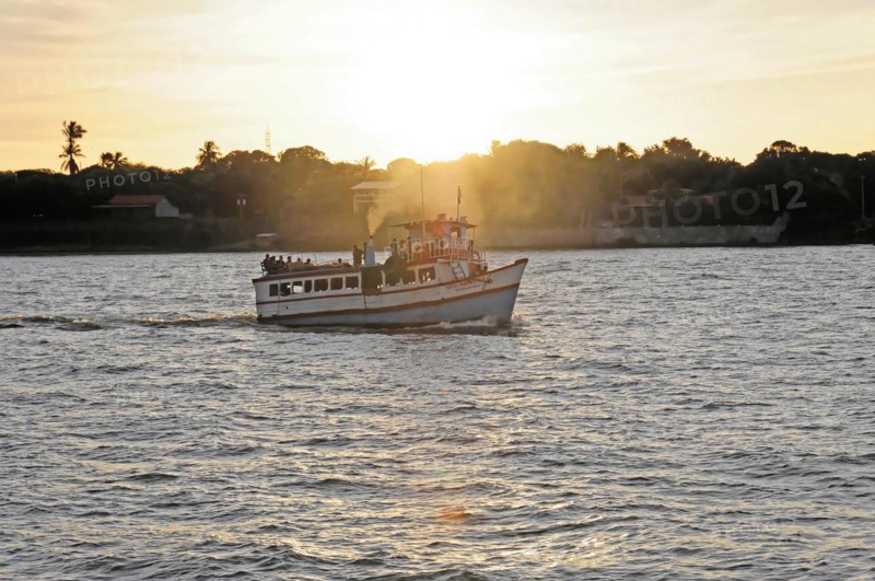 Lake Nicaragua, Ometepe Island in the background, Small boat on a lake at sunset, with light reflections on the water and silhouettes on board, Nicaragua, Central America, Central America