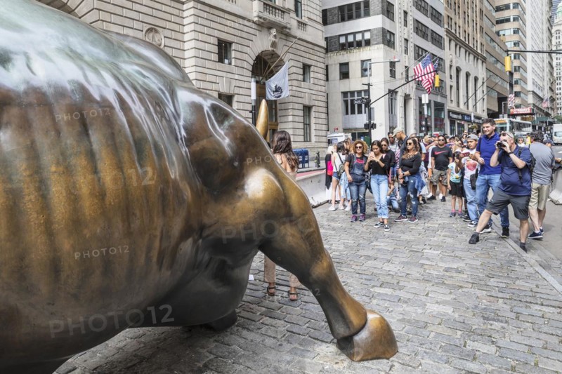 Tourists taking pictures in front of the bronze statue of the Charging Bull, Wall Street, Manhattan, New York City, New York, USA, New York City, New York, USA, North America
