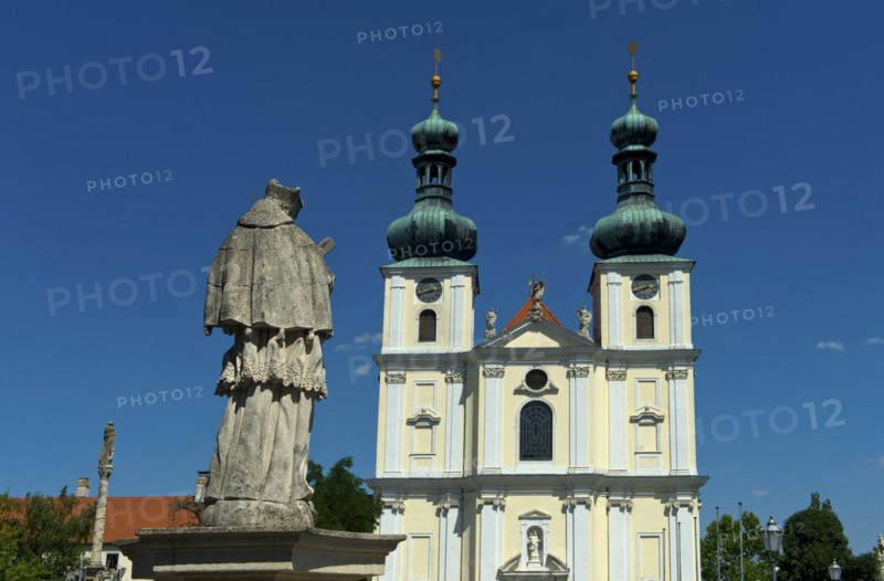 Double-tower facade of the Basilica of the Nativity of the Virgin Mary with Marian column, Roman Catholic pilgrimage church in the town of Frauenkirchen, Seewinkel, Burgenland, Austria, Europe