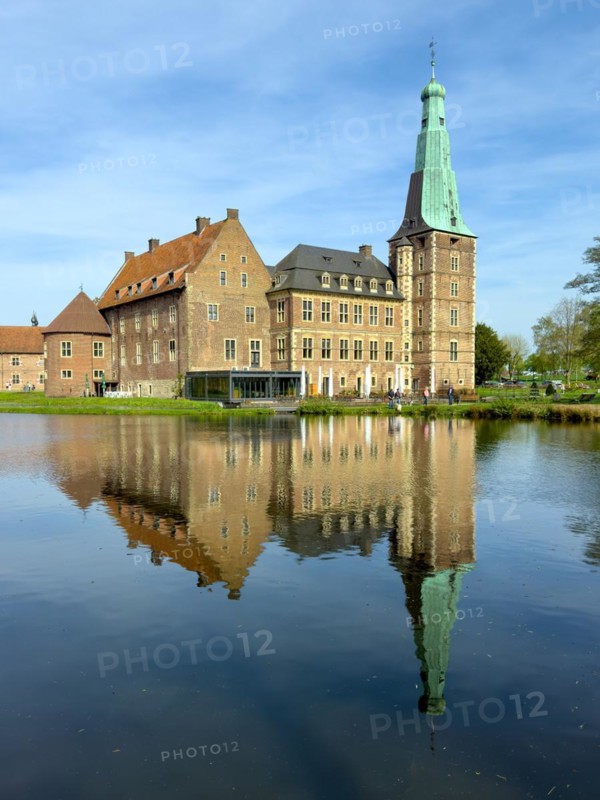 View over moat to historic moated castle from Renaissance Raesfeld Castle reflected in moat in spring, excursion destination in North Rhine-Westphalia, Freiheit Raesfeld, Muensterland, North Rhine-Westphalia, Germany, Europe