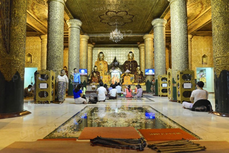 Shwedagon Pagoda, Yangon, Myanmar, Asia, Believers meditate in front of golden Buddha statues in a magnificent temple room, Asia