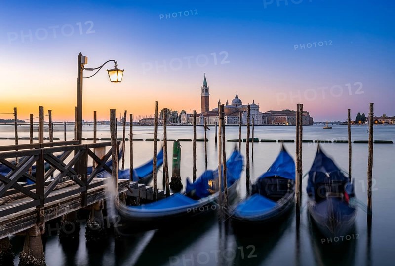 Venetian gondolas, boat dock at St Mark's Square, church of San Giorgio Maggiore in the background, long exposure at sunrise, Venice, Veneto, Italy, Europe