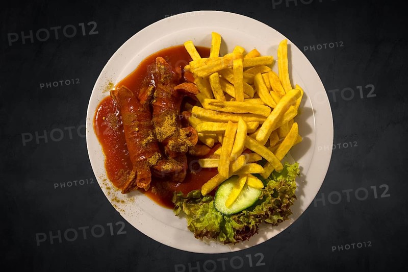 Currywurst with chips on a dark background, Franconia, Bavaria, Germany, Europe