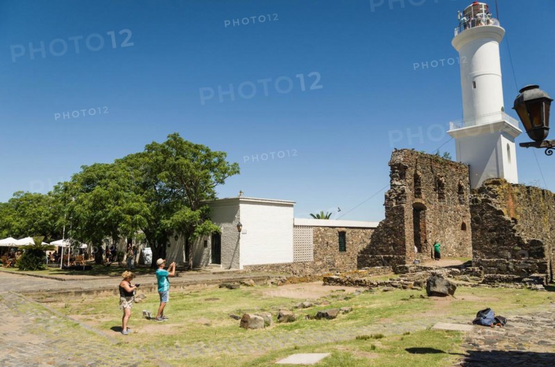 COLONIA DEL SACRAMENTO, URUGUAY, Dezember 30, 2023:Tourists photographing the Lighthouse in the city of Colonia del sacramento in Uruguay