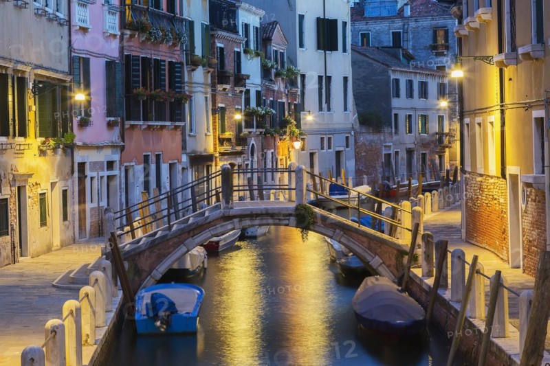 Moored boats and footbridge over Rio de la Toletta Canal with old architectural style residential buildings at dusk, Dorsoduro district, Venice, Veneto, Italy, Europe