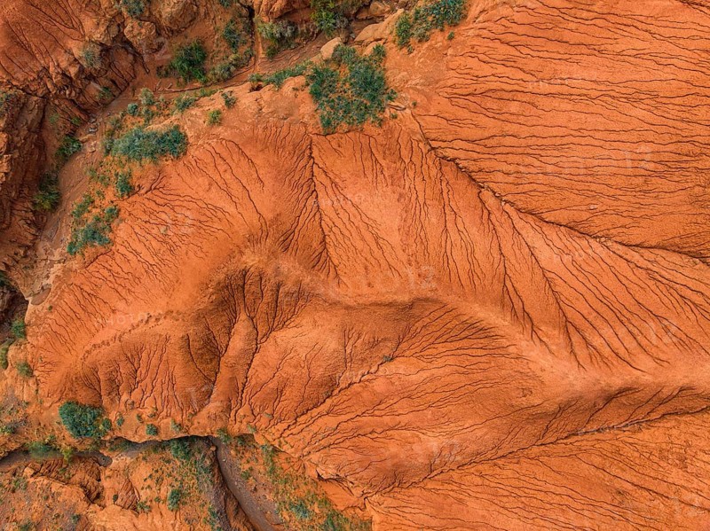 Top Down View, Badlands, river in a gorge with eroded red sandstone rocks, Konorchek Canyon, Boom Gorge, aerial view, Kyrgyzstan, Asia