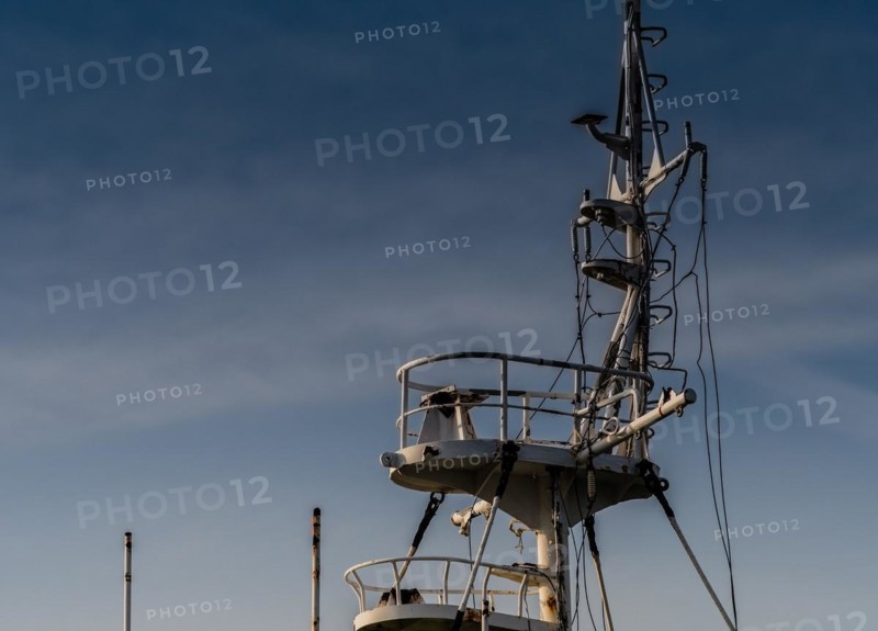 Closeup of rusted crows nest section of an old ship with a blue sky in the background in NamHae, South Korea, Asia