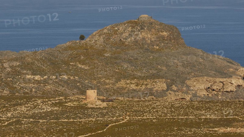 Ruins of a windmill, Hilly landscape with historical ruins and a path through the grass, Lindos, Rhodes, Dodecanese, Greek Islands, Greece, Europe