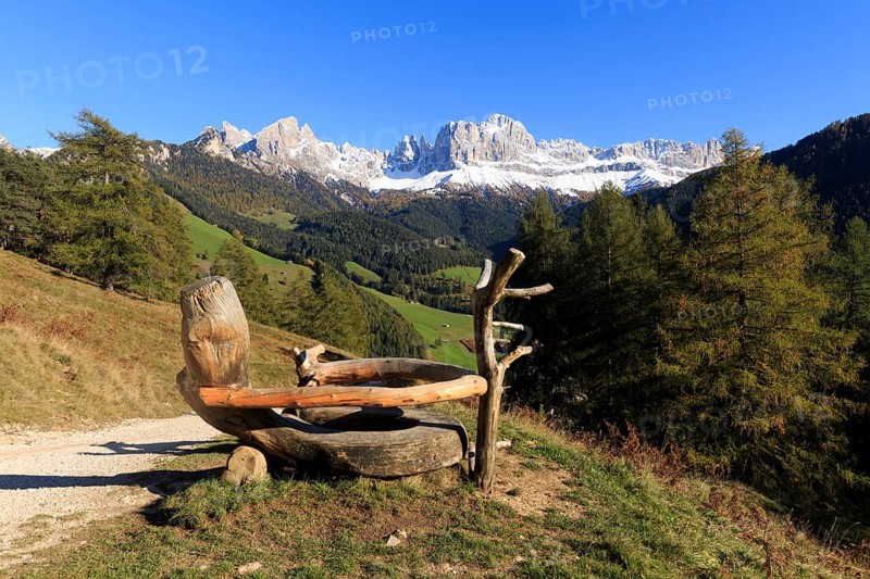 Mountain view from a rustic wooden bench on a sunny autumn day, Italy, TAlto Adige, Bolzano province, Dolomites, rose garden, Europe