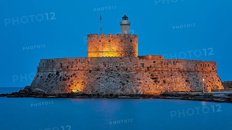 Ancient castle walls with a lighthouse in the blue hour in a quiet atmosphere, night shot, Fort of Saint Nikolaos, harbour promenade, Rhodes, Dodecanese, Greek Islands, Greece, Europe
