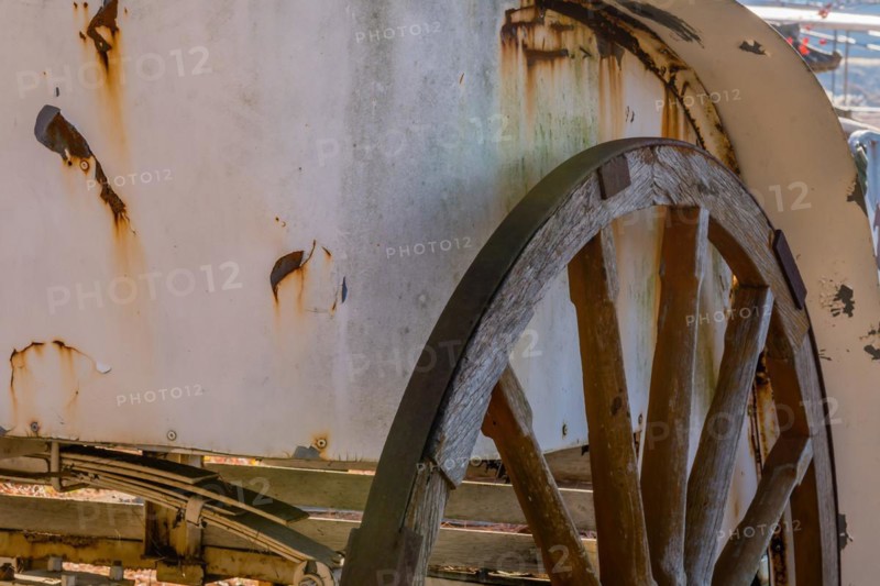 Closeup of antique wooden wheel on old rusted horse drawn carriage in South Korea