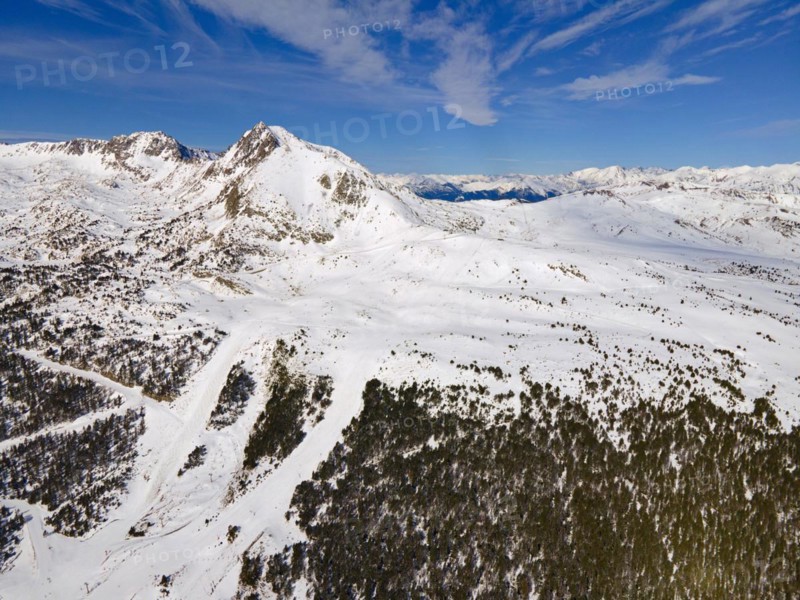 Wide-angle aerial view of snow-covered mountains and forest areas under a blue sky, Grau Roig, Encamp, Andorra, Pyrenees, Europe