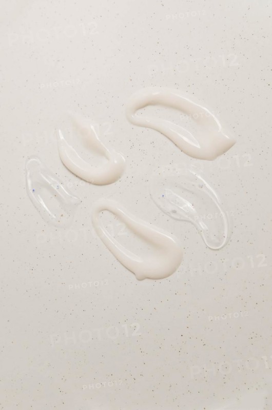 Cosmetic smears of creamy texture on a beige background