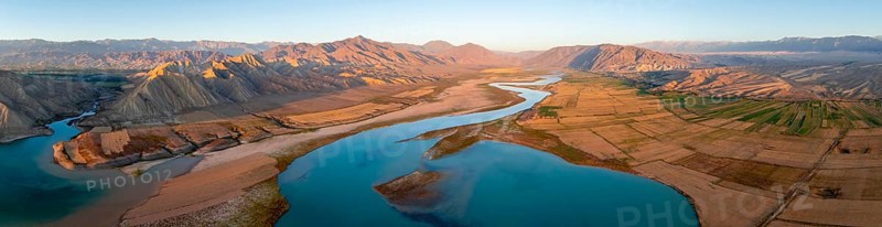 Naryn River between mountains and fields, at Toktogul Reservoir at sunset, aerial view, Kyrgyzstan, Asia