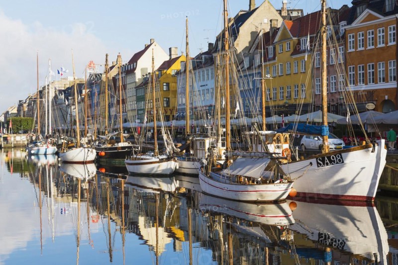 Moored sailboats and colourful 17th century apartment buildings and houses along the Nyhavn canal, Copenhagen, Denmark, Europe