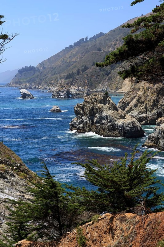 A rocky coast with trees falls steeply into the foamy sea, Big Sur Pfeiffer, US 1, North America, USA, South-West, California, California, North America