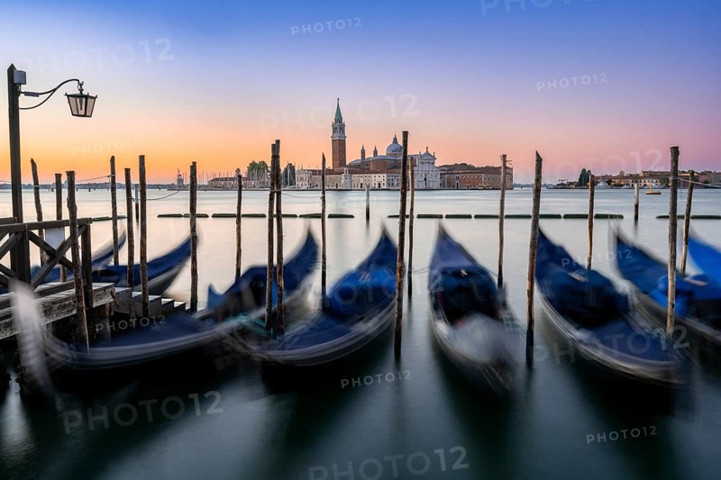 Venetian gondolas, boat dock at St Mark's Square, church of San Giorgio Maggiore in the background, long exposure at sunrise, Venice, Veneto, Italy, Europe