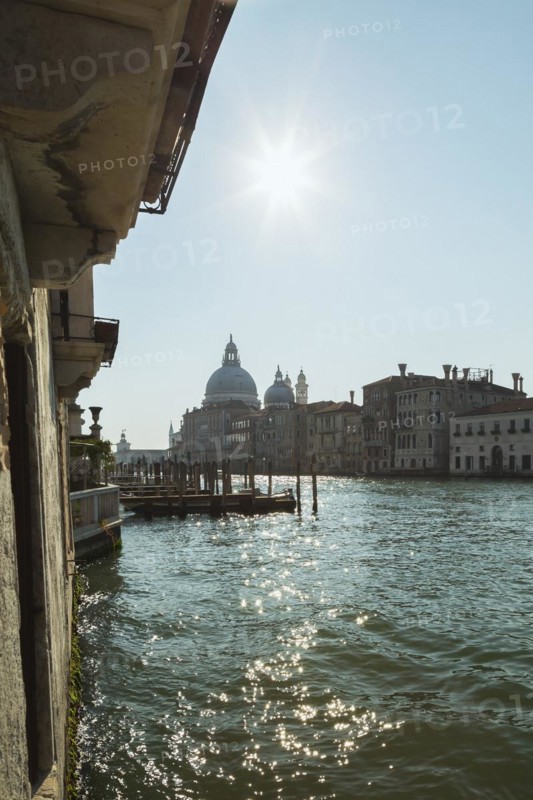 Silhouetted view of Grand Canal with Santa Maria della Salute basilica and Renaissance architectural style palace buildings in Dorsoduro, Venice, Veneto, Italy, Europe