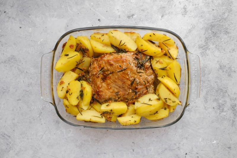 Top view of baked pork fillet with potato wedges